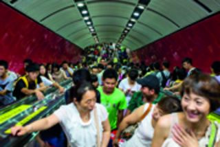 17 Jul 2013, Guangzhou, Guangdong Province, China --- --FILE--A crowd of passengers take escalators at a subway station in Guangzhou city, south Chinas Guangdong province, 17 July 2013. Guangzhou vice mayor Wang Dong said during a press conference that under southern citys current plans, they will offer free Wi-Fi in important public places such as tourist attractions, most government affairs halls, human resource markets, hospitals, transportation hubs, and parks, by 2015. At present, Guangzhou is actively building itself into a smart city and a major part of the plan is to construct and open free WLAN access points in public places. According to Wang, the city itself now provides 42 hotspot areas, where about 402 access points are available. By the end of June 2013, there were over 500 public access points in Guangzhou, providing free WLAN services to 360,000 people. --- Image by © Imaginechina/Corbis